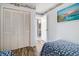 Bright bedroom featuring a nautical theme, closet, and connecting door to bathroom at 1425 S Ocean Blvd. # 2A, North Myrtle Beach, SC 29582