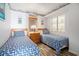 A cozy bedroom with twin beds featuring patterned blue bedding, themed decor, and wood-look flooring at 1425 S Ocean Blvd. # 2A, North Myrtle Beach, SC 29582