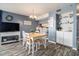 Dining area adjacent to wet bar featuring a wooden table with white chairs with light blue walls at 1425 S Ocean Blvd. # 2A, North Myrtle Beach, SC 29582