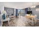 Open concept living space with dining area featuring a wooden table set and a sliding glass door to a balcony at 1425 S Ocean Blvd. # 2A, North Myrtle Beach, SC 29582