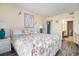 A sunlit main bedroom with a colorful bedspread and access to an ensuite bathroom at 1425 S Ocean Blvd. # 2A, North Myrtle Beach, SC 29582