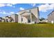 Large backyard showing lawn, patio, and surrounding neighborhood homes at 1560 Swing Bridge Way, Myrtle Beach, SC 29588