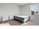Bedroom features a large window with blinds and a white nightstand for ample storage at 1560 Swing Bridge Way, Myrtle Beach, SC 29588