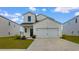 Charming two-story home features a two-car garage, manicured lawn, and classic white siding at 1560 Swing Bridge Way, Myrtle Beach, SC 29588