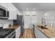 Well-equipped kitchen with stainless steel appliances, white cabinets, and sleek granite countertops at 1560 Swing Bridge Way, Myrtle Beach, SC 29588