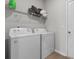Functional laundry area with washer, dryer, and overhead storage shelving at 1560 Swing Bridge Way, Myrtle Beach, SC 29588