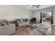 Bright living room with a comfortable sofa, area rug, and access to the backyard at 1560 Swing Bridge Way, Myrtle Beach, SC 29588