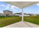 View from the covered patio overlooking a fenced backyard and neighboring homes at 1560 Swing Bridge Way, Myrtle Beach, SC 29588