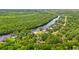 Features the home nestled among vibrant greenery, and river access at 1936 Lees Landing Circle, Conway, SC 29526