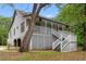 Exterior showcases the home's design with a wrap-around porch and complemented by lush greenery at 1936 Lees Landing Circle, Conway, SC 29526