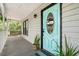 Close-up of the front door with turquoise paint, porch swing, and stylish plants enhancing the entrance at 1936 Lees Landing Circle, Conway, SC 29526