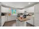 Bright kitchen features white cabinets, granite counters, stainless steel appliances, and center island at 1936 Lees Landing Circle, Conway, SC 29526