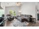 Cozy living room featuring a sectional sofa, ceiling fan, and lots of natural light at 1936 Lees Landing Circle, Conway, SC 29526