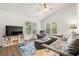 Comfortable living room with plush seating, a ceiling fan, and lots of natural light from large windows at 1936 Lees Landing Circle, Conway, SC 29526