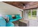 Relax on this screened porch featuring comfortable seating, fan and wooded views at 1936 Lees Landing Circle, Conway, SC 29526