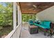 Relax on this screened porch featuring comfortable seating, fan and views at 1936 Lees Landing Circle, Conway, SC 29526