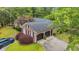 Aerial view of a well-maintained home with a two-car garage, mature trees, an American flag, and a lush lawn at 196 John Waites Ct., Georgetown, SC 29440