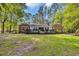 Spacious backyard featuring a large deck, lush lawn, and mature trees for outdoor enjoyment at 196 John Waites Ct., Georgetown, SC 29440