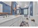 Bathroom with double sink vanity, white cabinets, blue walls, and tub/shower combo at 196 John Waites Ct., Georgetown, SC 29440