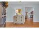 Entryway featuring wood floors, a vintage dresser with a lamp, and an open doorway to the living area at 196 John Waites Ct., Georgetown, SC 29440