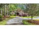 Charming brick home featuring a circular driveway, mature trees, and lush landscaping at 196 John Waites Ct., Georgetown, SC 29440