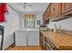 Functional laundry room with wood cabinets, sink, washer, and dryer at 196 John Waites Ct., Georgetown, SC 29440