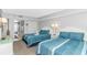 Stylishly decorated bedroom featuring 2 beds with blue striped linens and partial view into the bathroom at 2000 N Ocean Blvd. # Ph 15, Myrtle Beach, SC 29577