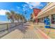 Picturesque boardwalk view featuring palm trees, beach access, and various shops and attractions on a sunny day at 2000 N Ocean Blvd. # Ph 15, Myrtle Beach, SC 29577