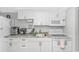 Bright kitchen featuring white appliances, cabinets, and a sink with a marble-style countertop at 2000 N Ocean Blvd. # Ph 15, Myrtle Beach, SC 29577