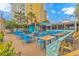Spacious outdoor dining area with blue chairs, wooden tables, and string lights for a relaxed ambiance at 2000 N Ocean Blvd. # Ph 15, Myrtle Beach, SC 29577