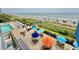Elevated view of oceanfront condo amenities with a pool and comfortable lounge chairs at 2001 S Ocean Blvd. # 303, Myrtle Beach, SC 29577