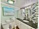 Clean bathroom with granite countertop, mosaic tile backsplash, and coastal artwork at 2001 S Ocean Blvd. # 303, Myrtle Beach, SC 29577