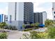 Coastal condominium building with blue accents, palm trees, and well-maintained landscaping at 2001 S Ocean Blvd. # 303, Myrtle Beach, SC 29577