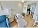Cozy living area featuring neutral decor, comfortable seating and tile floors leading to kitchen at 2001 S Ocean Blvd. # 303, Myrtle Beach, SC 29577