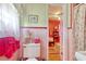 Bathroom doorway view into a pink bedroom with bed and furnishings, including pink tile and trim at 2004 Seitter St., Georgetown, SC 29440