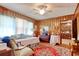 Cozy bedroom with wood paneled walls, ceiling fan, and bright red rug at 2004 Seitter St., Georgetown, SC 29440