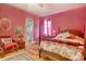 Bedroom boasts a four-poster bed, hardwood floors, a ceiling fan, and a charming wicker chair at 2004 Seitter St., Georgetown, SC 29440