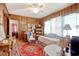 Wood paneled bedroom with ceiling fan, and view into a sitting area at 2004 Seitter St., Georgetown, SC 29440