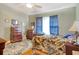 Bedroom with hardwood floors, leafy comforter and curtains with a view of a blue sky through the window at 2004 Seitter St., Georgetown, SC 29440