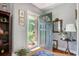 Entryway with hardwood floors, a blue accent rug, and walls with pale-grey paint and decorative wall hangings at 2004 Seitter St., Georgetown, SC 29440