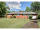 Charming brick home with a well-maintained lawn, mature trees, and an attached one-car garage at 2004 Seitter St., Georgetown, SC 29440