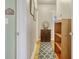 Hallway with hardwood floors and accent rug features a cabinet, shelves and pictures on the wall at 2004 Seitter St., Georgetown, SC 29440