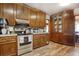 Kitchen with wooden cabinets, stainless steel appliances, tile backsplash, and updated flooring at 2004 Seitter St., Georgetown, SC 29440
