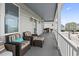 Spacious balcony with wicker furniture, colorful cushions, and a picturesque neighborhood view at 204 33Rd Ave. N, North Myrtle Beach, SC 29582