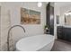 Modern bathroom with a freestanding tub, dark cabinets, stylish decor, and unique fixtures at 204 33Rd Ave. N, North Myrtle Beach, SC 29582