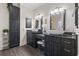 Modern bathroom featuring dual sinks, granite countertops, and elegant dark wood cabinetry for a luxurious feel at 204 33Rd Ave. N, North Myrtle Beach, SC 29582
