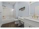 Bright bathroom featuring a shower-tub combo, vanity with a makeup area, and blue walls at 204 33Rd Ave. N, North Myrtle Beach, SC 29582