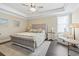 Relaxing bedroom featuring a tufted headboard, accent pillows, a ceiling fan, and soft lighting at 204 33Rd Ave. N, North Myrtle Beach, SC 29582