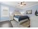 Light-filled bedroom with blue walls, ceiling fan, and a comfortable queen-sized bed at 204 33Rd Ave. N, North Myrtle Beach, SC 29582