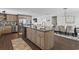 Open-concept kitchen with gray cabinets, a granite island, stainless steel appliances, and a dining area at 204 33Rd Ave. N, North Myrtle Beach, SC 29582